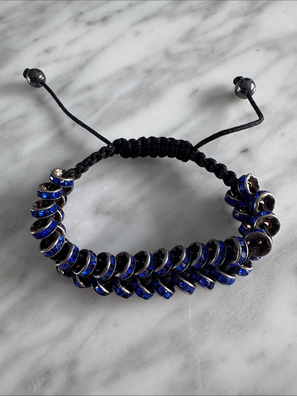 Double row blue crystal rings braided cord adjustable bracelet.